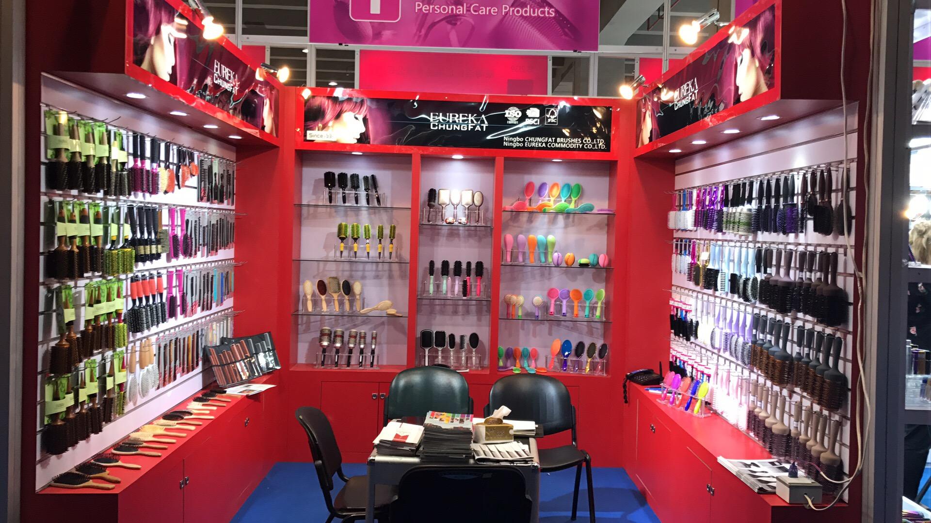 Front view of the red Eureka and Chungfat booth at the Canton Fair, with hairbrush displays on three sides