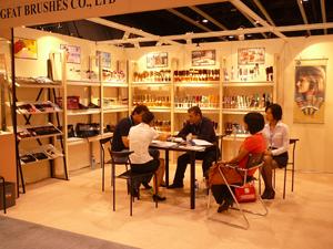 Visitors seated at meeting tables inside the warmly lit Chungfat booth at a Hong Kong exhibition